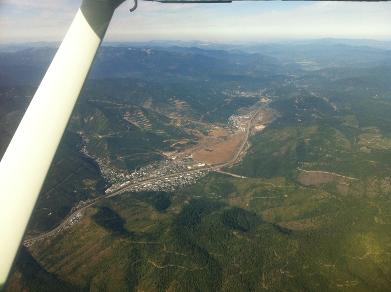 Scaled image Passing Kellogg_ ID (near)_ I-90_ and Shoshone County Airport (middle distance_ runway viewed end on) on the flight back to Fort Collins.jpg 