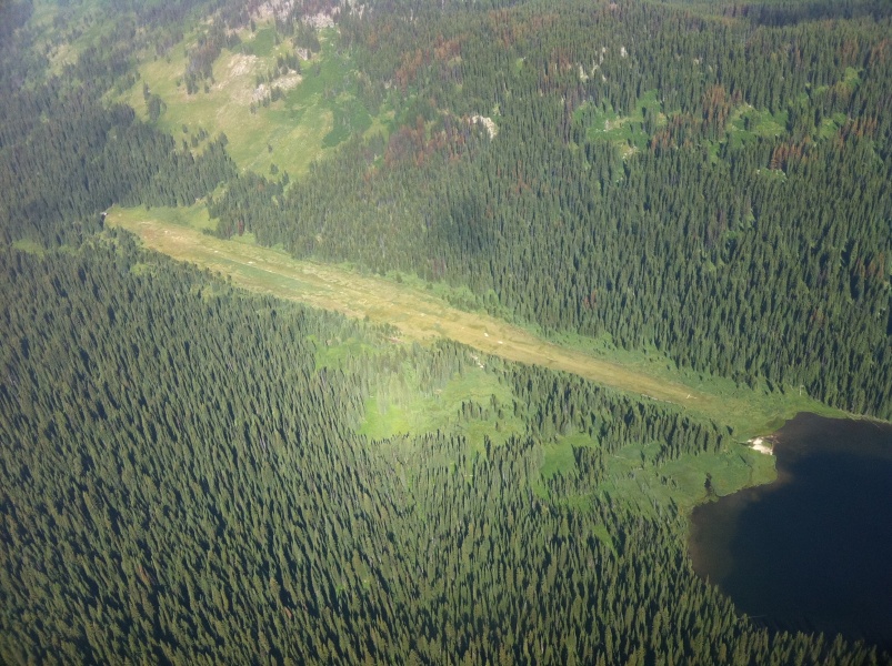 Scaled image US Forest Service airstrip at Fish Lake_ ID 2650 long_ elevation 5646 MSL with ranger cabin at left end and all in the Selway Bitterroot Wilderness.jpg 